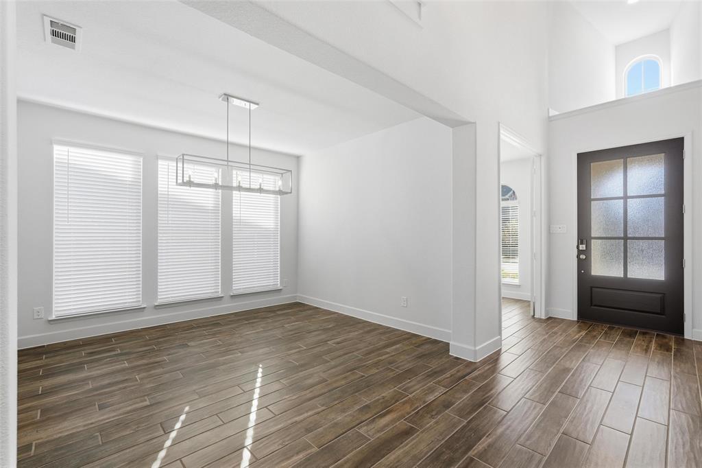 3329 Lacebark Lane Celina, TX 75009 - Photo 2 of 35 an empty room with wooden floor and a window