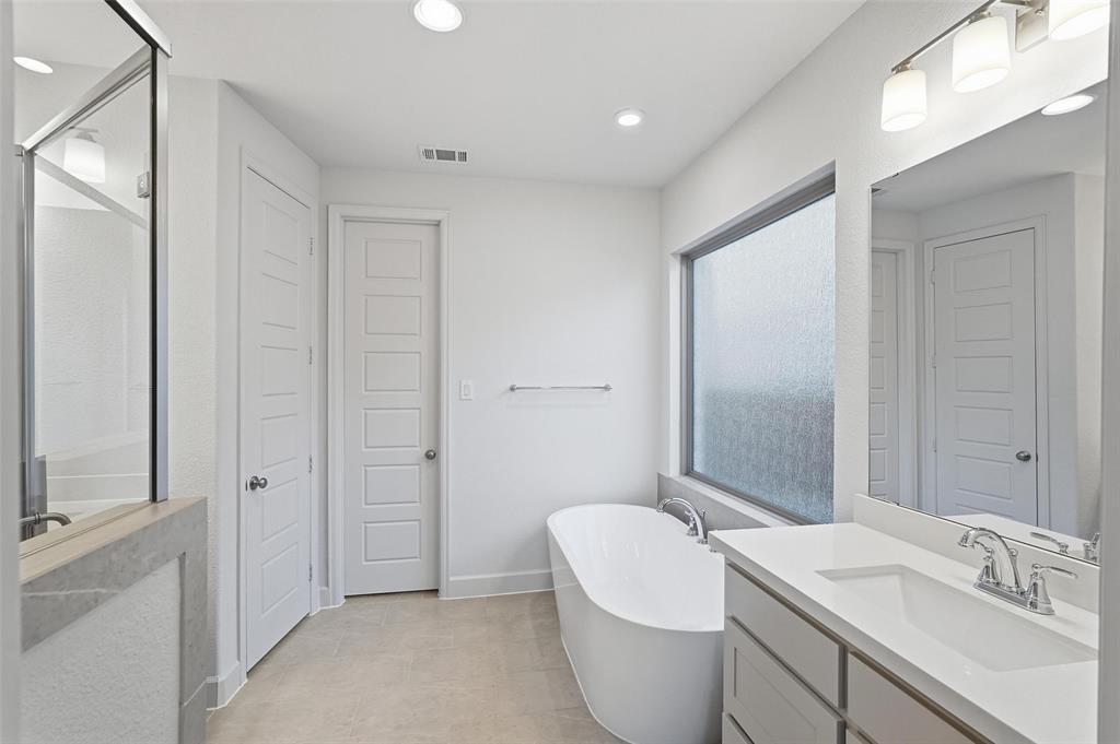 3329 Lacebark Lane Celina, TX 75009 - Photo 22 of 35 a bathroom with a toilet a sink and a mirror