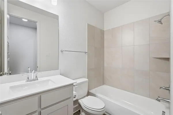 a bathroom with a shower sink and mirror