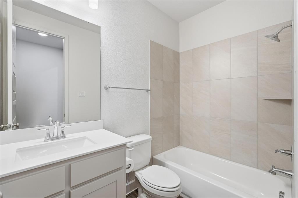 3329 Lacebark Lane Celina, TX 75009 - Photo 23 of 35 a bathroom with a sink a toilet and shower