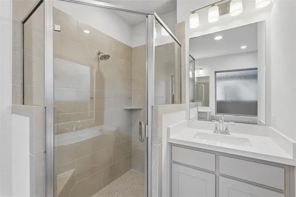 a bathroom with a sink toilet and shower