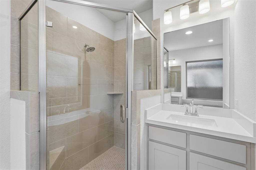 3329 Lacebark Lane Celina, TX 75009 - Photo 24 of 35 a bathroom with a shower sink and mirror