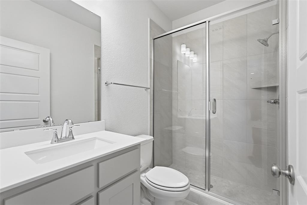 3329 Lacebark Lane Celina, TX 75009 - Photo 25 of 35 a bathroom with a sink toilet and shower