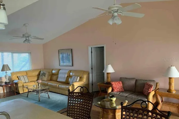 a living room with furniture and a lamp