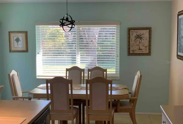 a view of a dining room with furniture and window