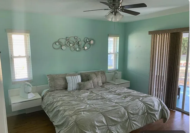 a bedroom with a large bed and a chandelier