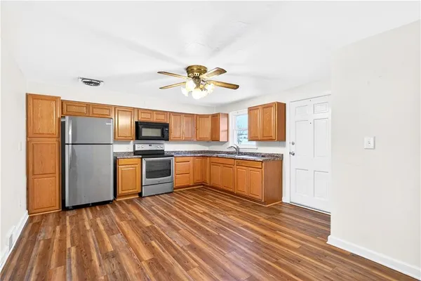 a kitchen with granite countertop a refrigerator and a stove