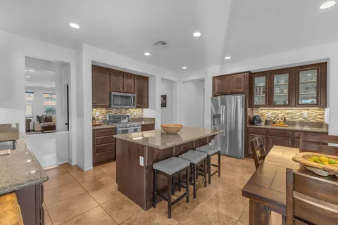 a kitchen with refrigerator and cabinets