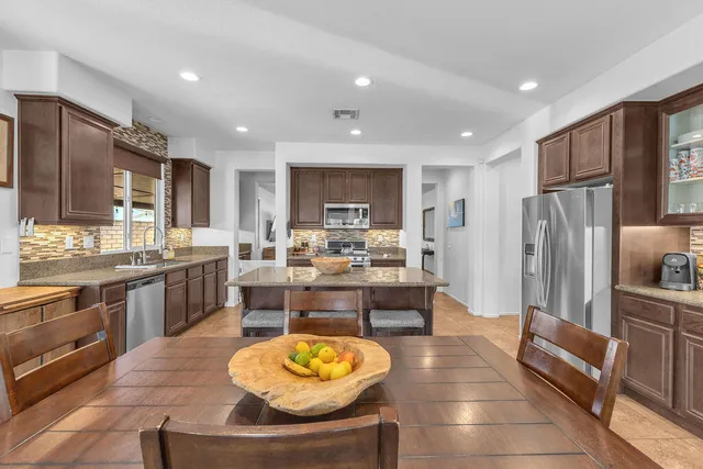 a view of a dining room with furniture and a kitchen