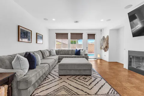 a living room with furniture and a mirror