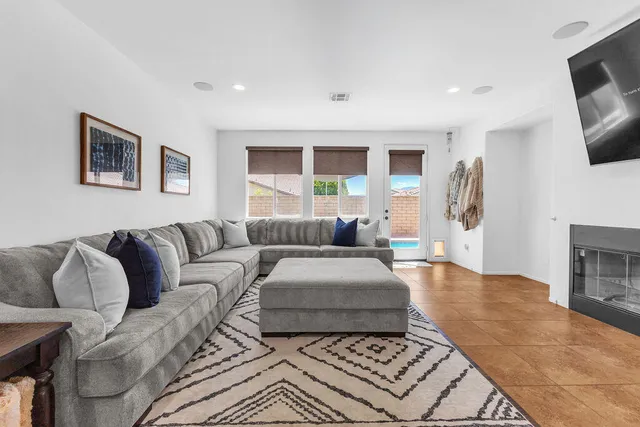a living room with furniture and a mirror