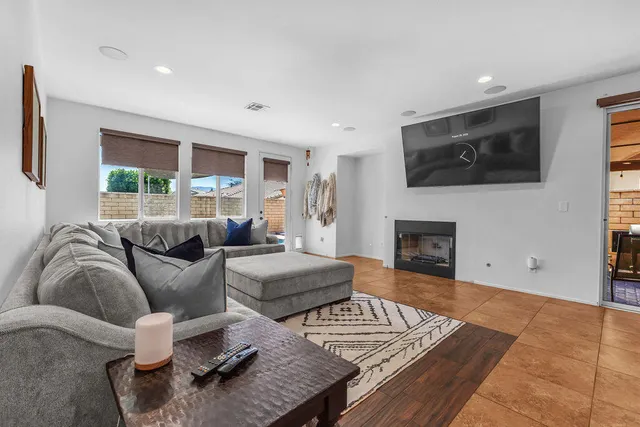 a living room with furniture and a ceiling fan