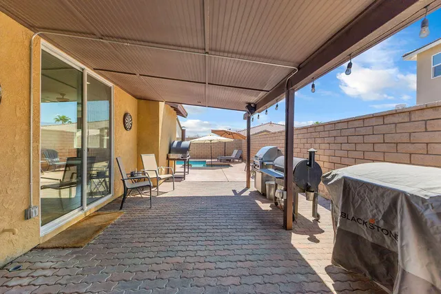 an aerial view of residential houses with outdoor space and ocean view