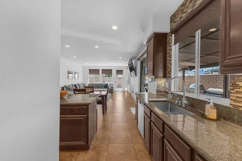 a kitchen with stainless steel appliances granite countertop wooden cabinets stove top oven and sink