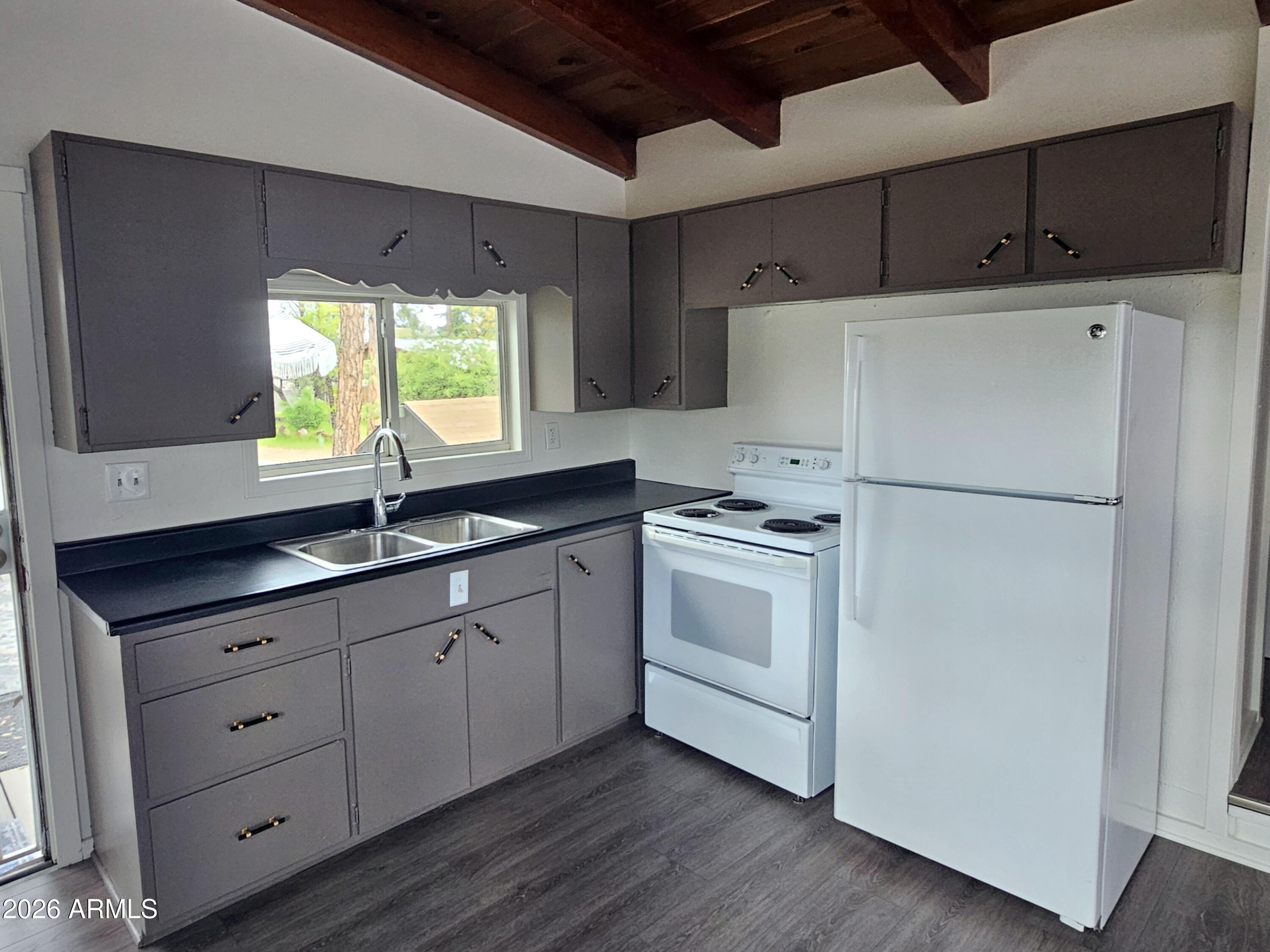 200 East Frontier Street Payson, AZ 85541 - Photo 3 of 8 a kitchen with white cabinets and white appliances