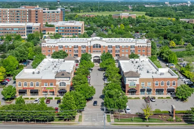 an aerial view of multiple houses with yard
