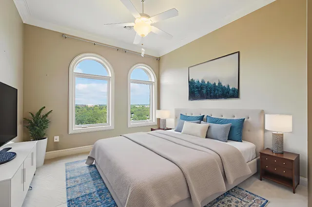 a bedroom with bed and a large window