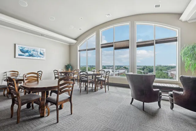 a living room with furniture and a floor to ceiling window