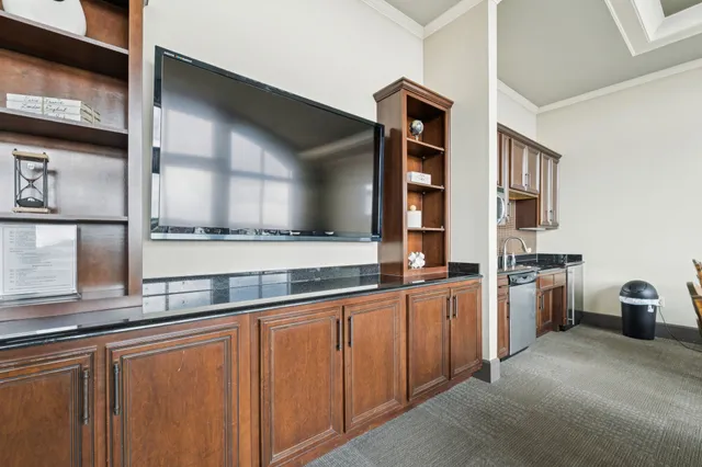 a kitchen with granite countertop a sink and a stove