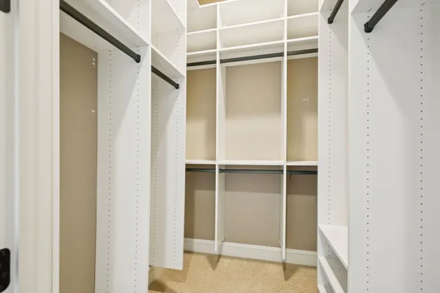 a large kitchen with granite countertop lots of counter space and stainless steel appliances