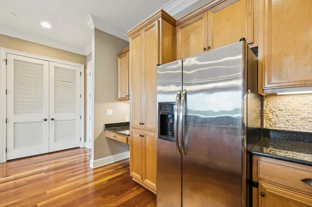a kitchen with stainless steel appliances granite countertop a refrigerator and a sink
