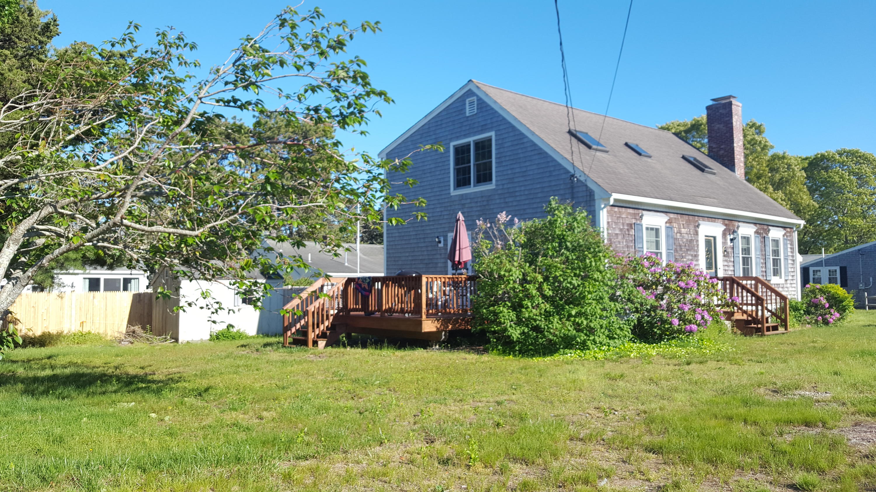 14 Bain Road Dennis Port, MA 02639 - Photo 1 of 22 a front view of a house with garden