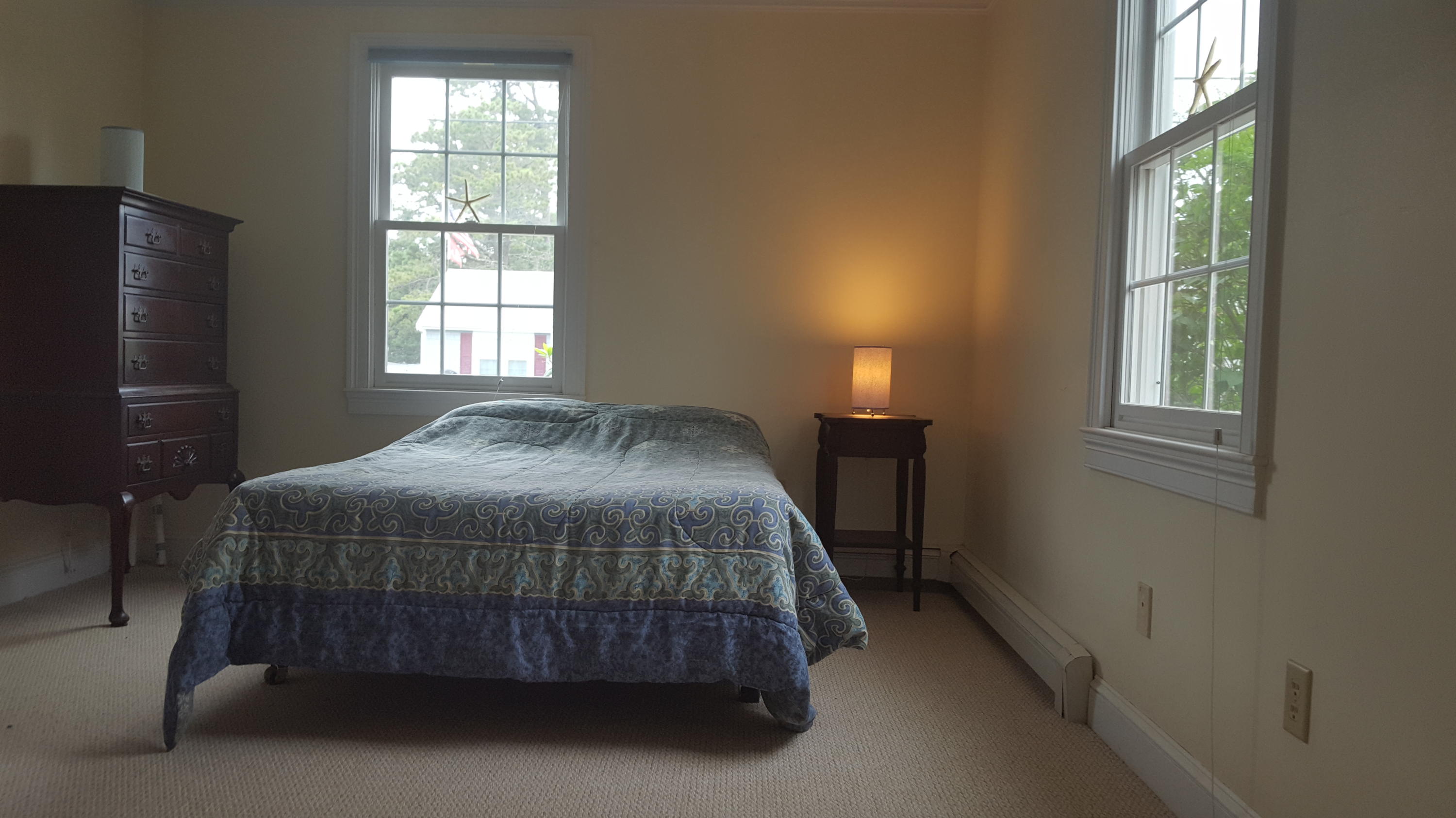 14 Bain Road Dennis Port, MA 02639 - Photo 9 of 22 a bedroom with a bed lamp and a window