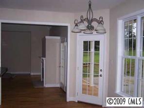842 Linneys Mill Road Union Grove, NC 28689 - Photo 2 of 8 a view of a hallway with wooden floor and a chandelier