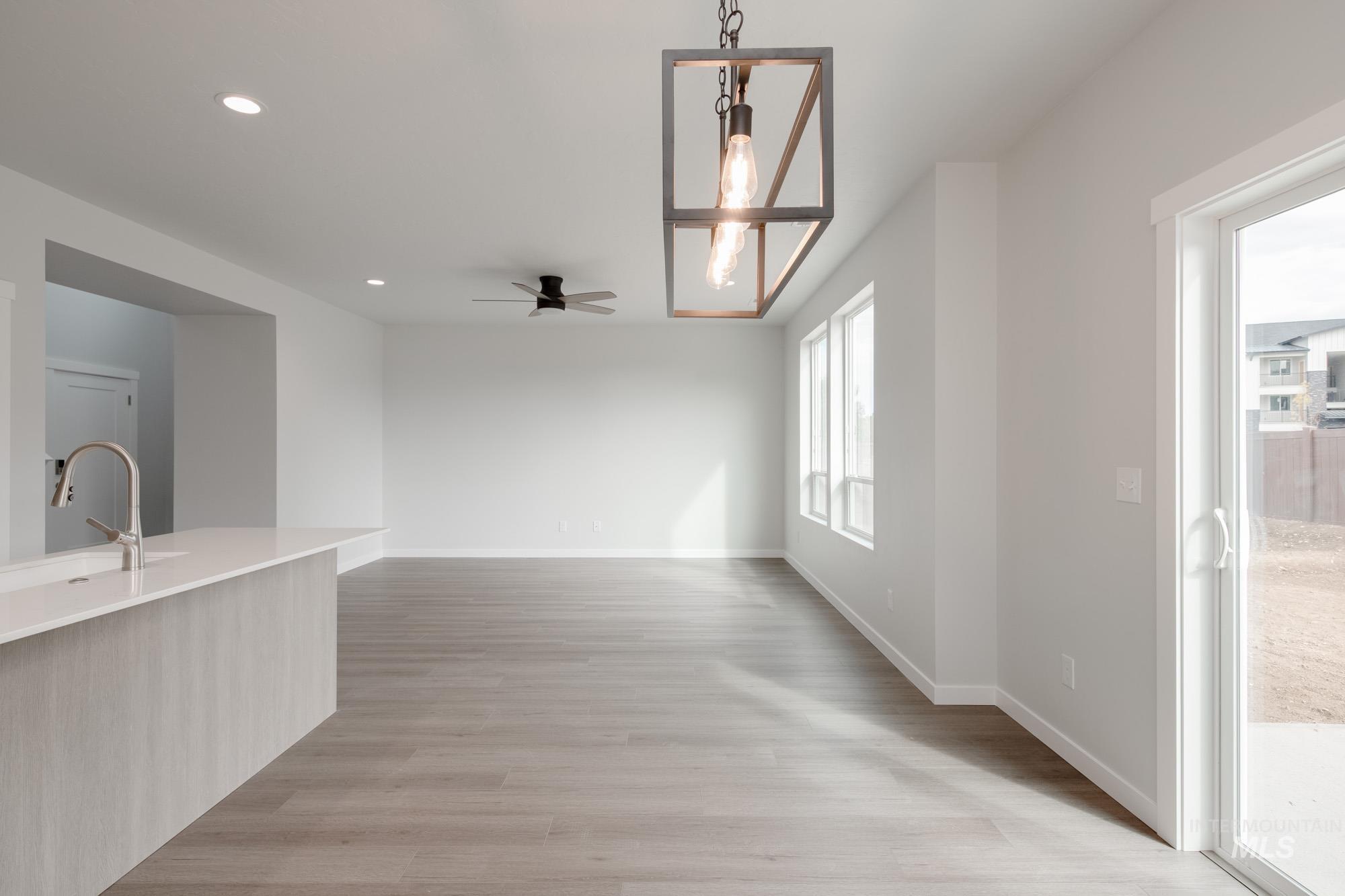 910 North Mirror Creek Way Meridian, ID 83642 - Photo 11 of 27 Unfurnished dining area with light wood finished floors, recessed lighting, and ceiling fan