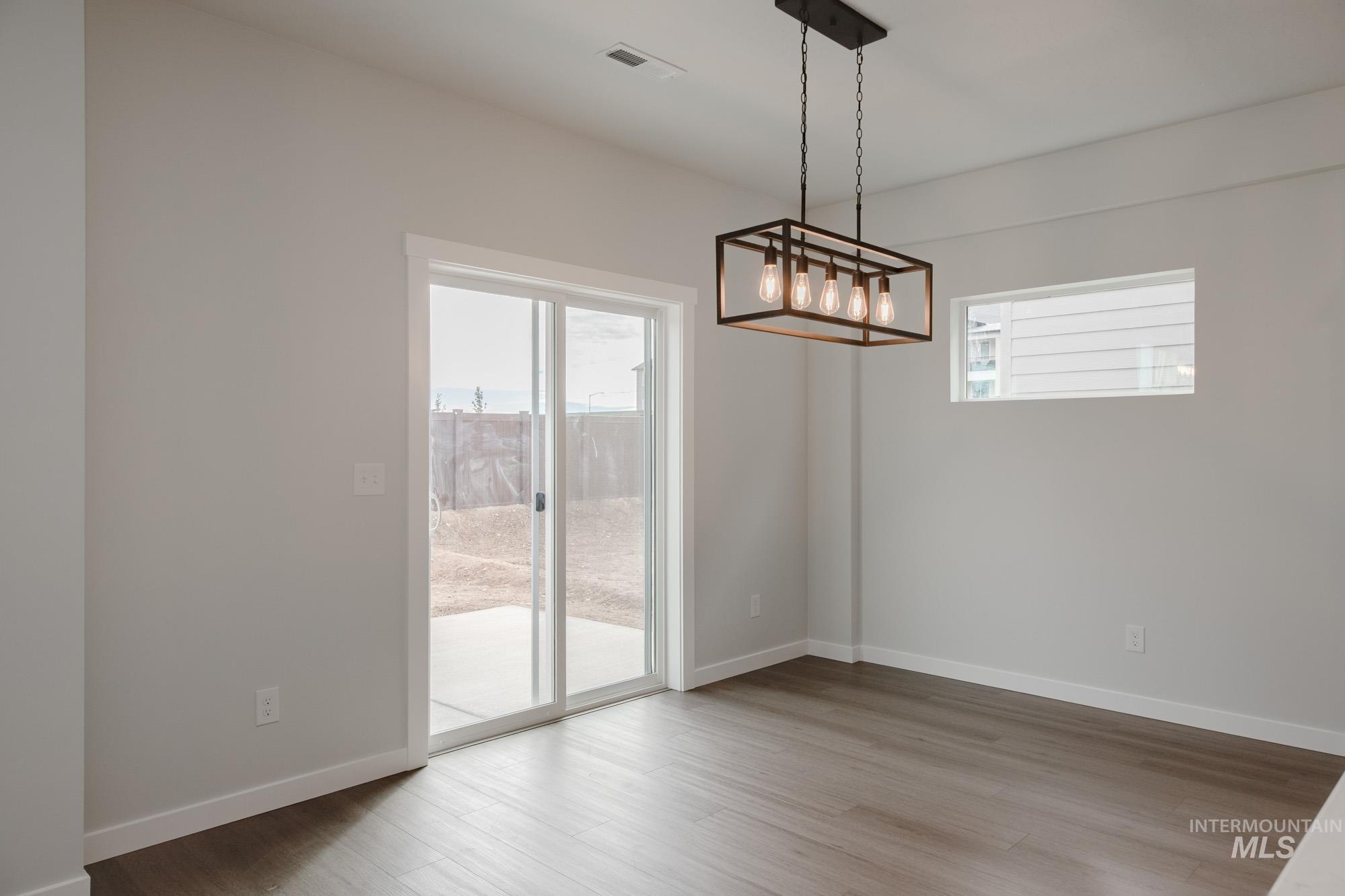 910 North Mirror Creek Way Meridian, ID 83642 - Photo 12 of 27 Unfurnished dining area with plenty of natural light and light wood-style flooring