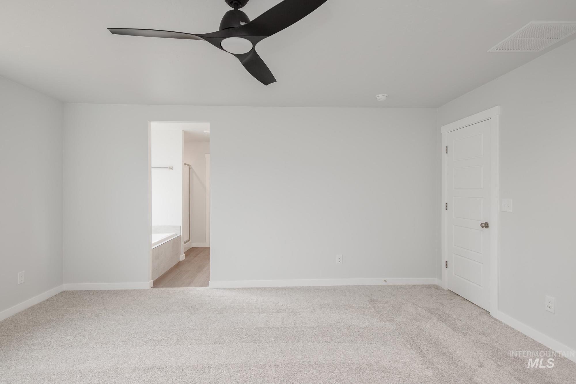 910 North Mirror Creek Way Meridian, ID 83642 - Photo 16 of 27 Unfurnished room featuring light colored carpet and a ceiling fan