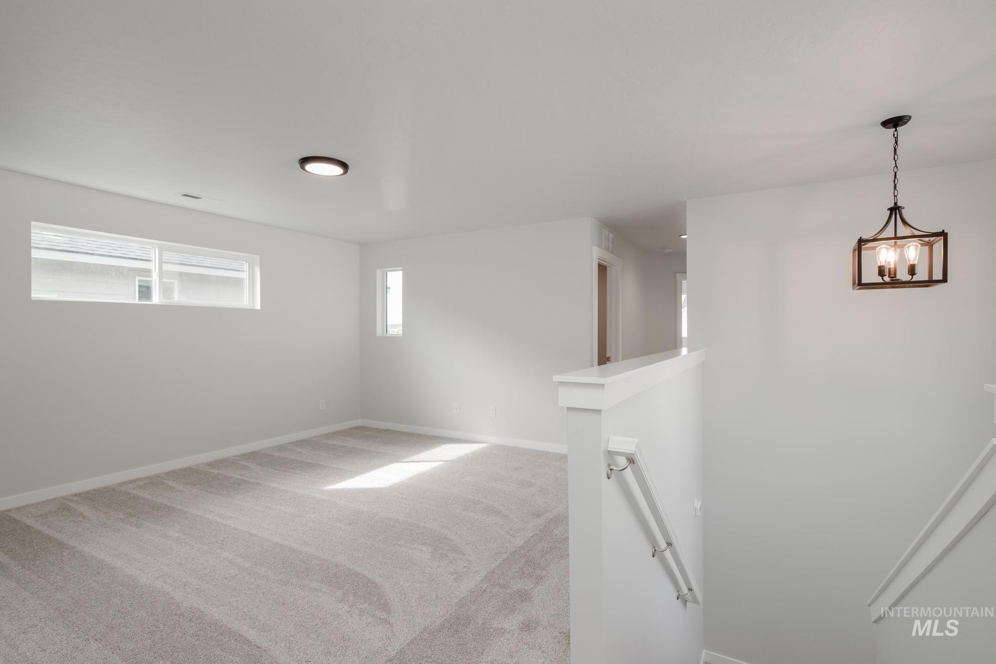 910 North Mirror Creek Way Meridian, ID 83642 - Photo 20 of 27 Empty room featuring light colored carpet and baseboards