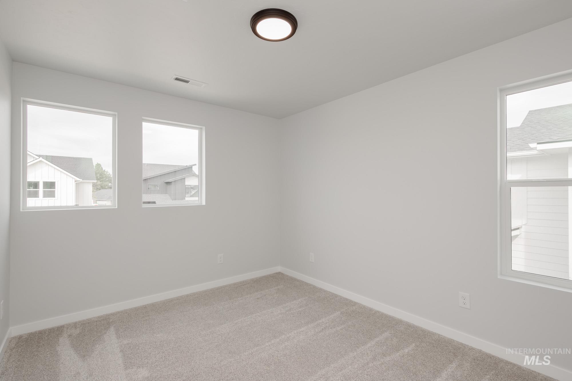 910 North Mirror Creek Way Meridian, ID 83642 - Photo 22 of 27 Empty room with carpet floors and baseboards