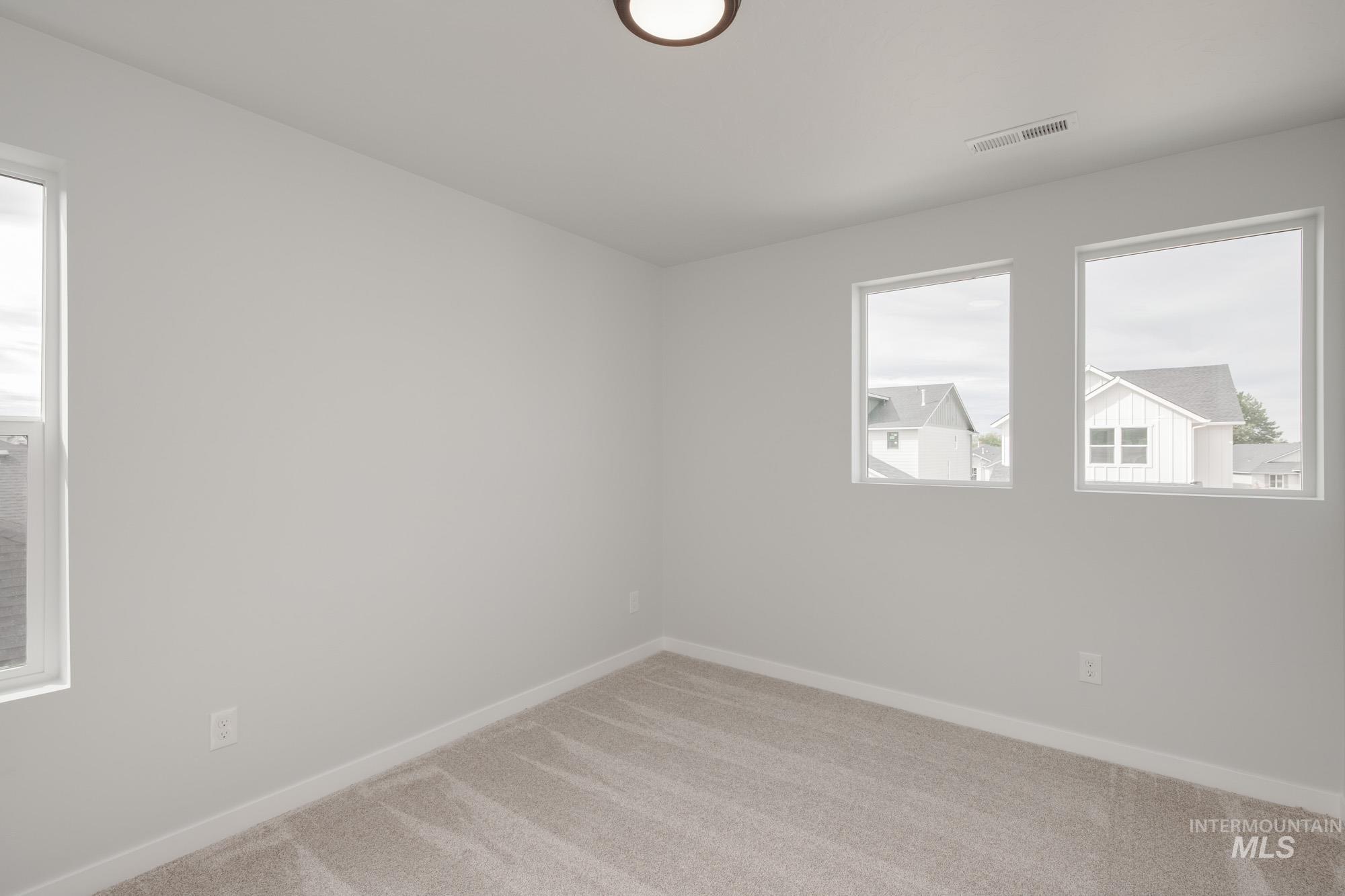 910 North Mirror Creek Way Meridian, ID 83642 - Photo 23 of 27 Carpeted spare room featuring baseboards