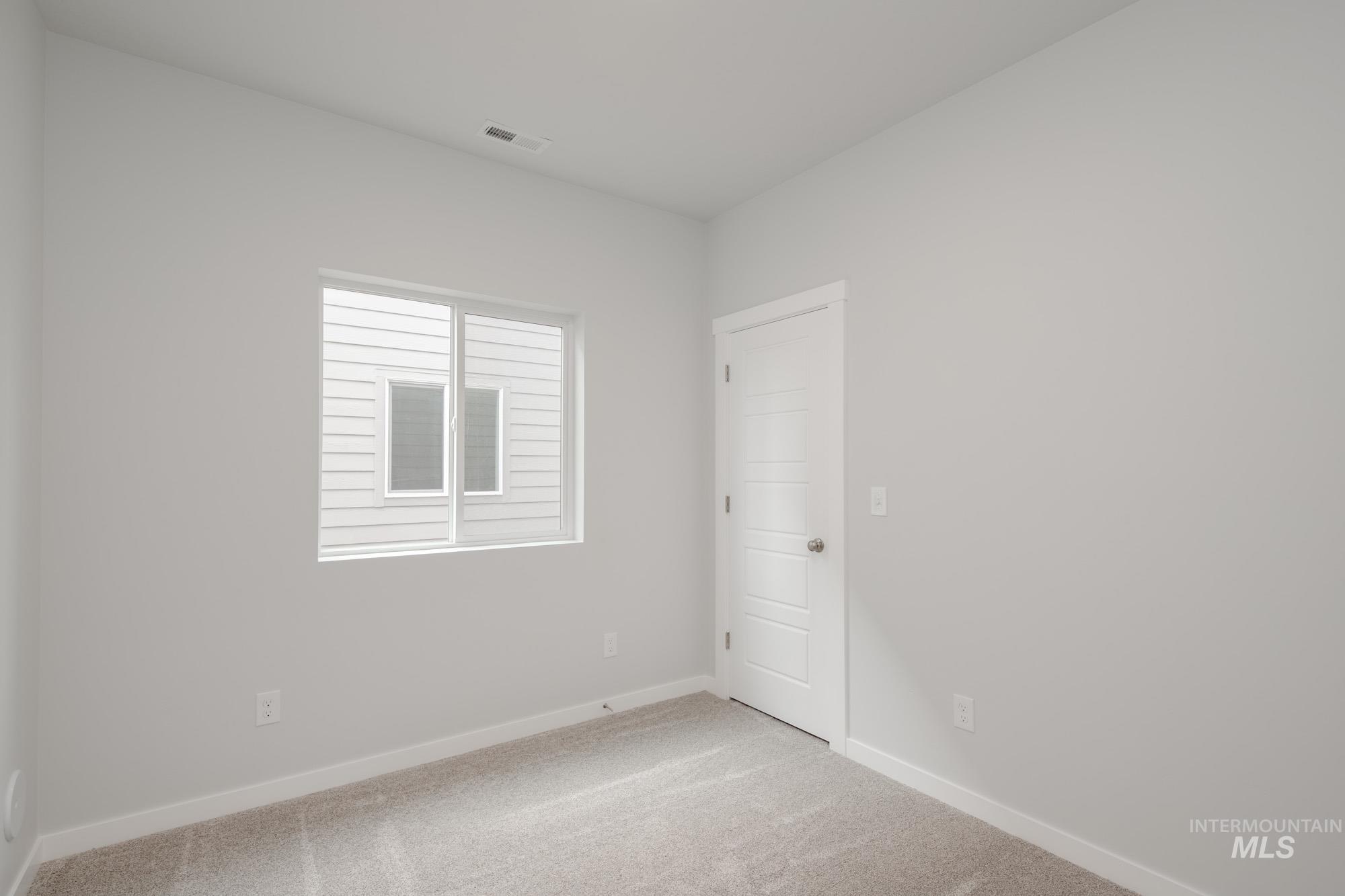 910 North Mirror Creek Way Meridian, ID 83642 - Photo 3 of 27 Carpeted empty room featuring baseboards