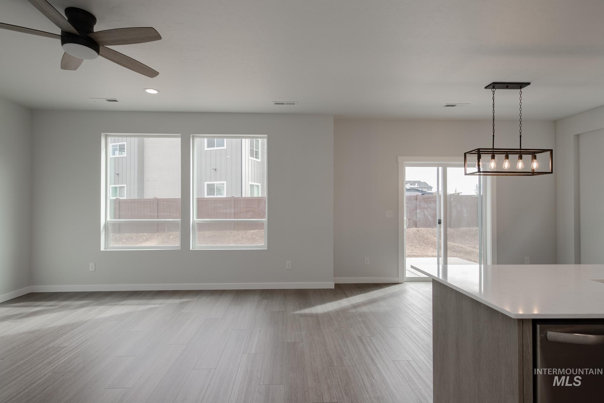 910 North Mirror Creek Way Meridian, ID 83642 - Photo 7 of 27 Unfurnished dining area with light wood-type flooring, recessed lighting, and ceiling fan