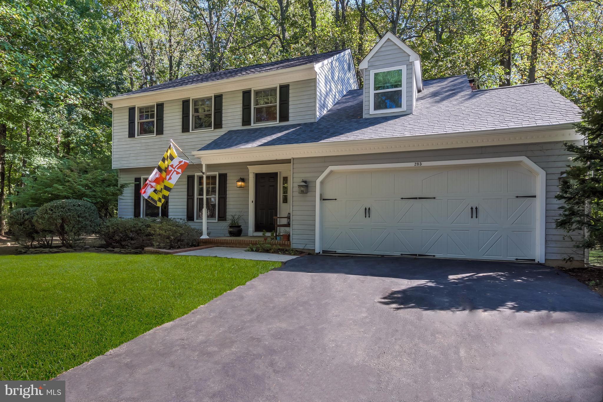 285 Locust Ridge Lane Arnold, MD 21012 - Photo 1 of 24 a front view of a house with a yard and garage