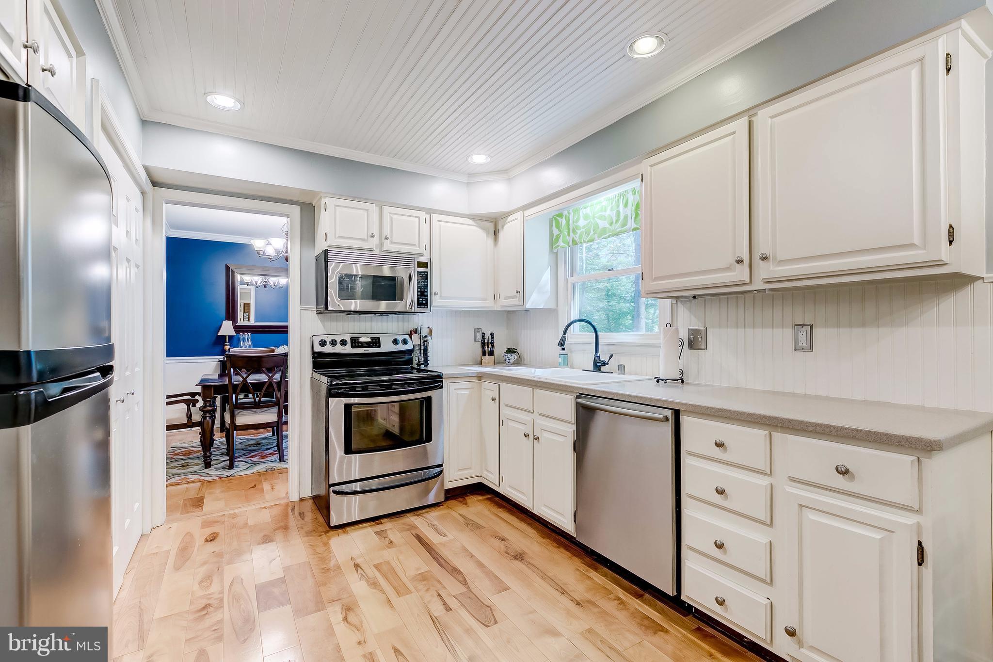 285 Locust Ridge Lane Arnold, MD 21012 - Photo 3 of 24 a kitchen with granite countertop a sink stainless steel appliances and cabinets