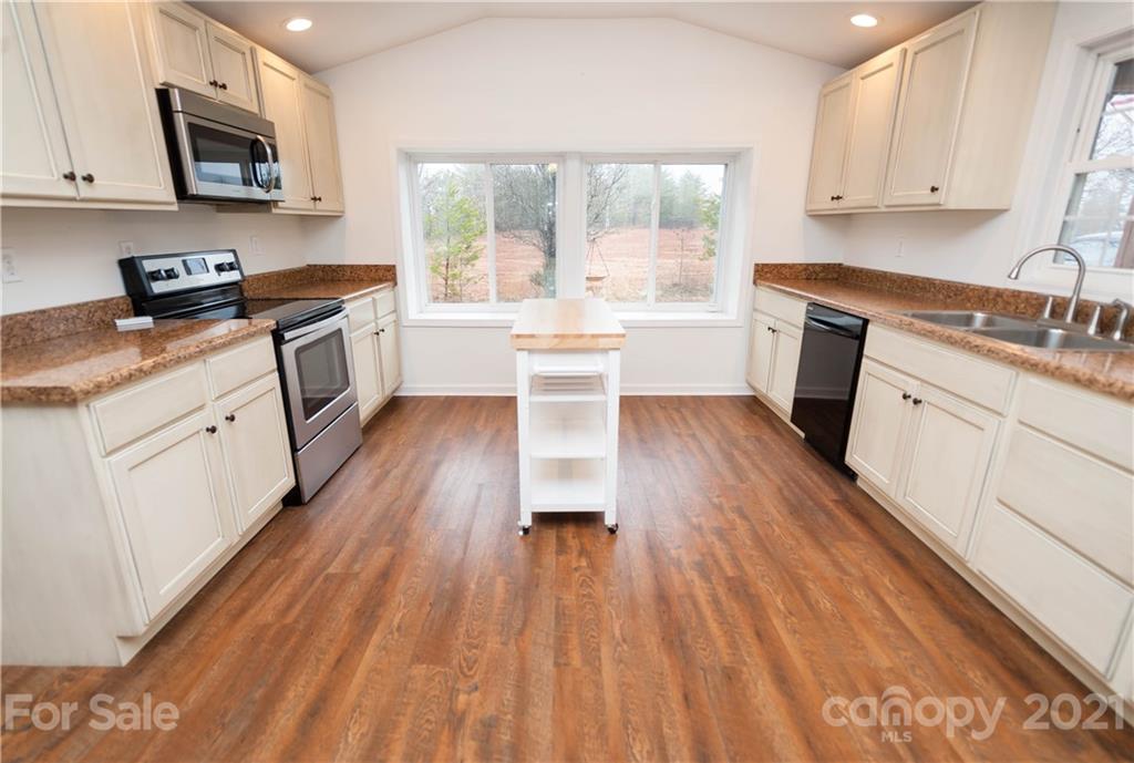 4266 Big Island Road Rutherfordton, NC 28139 - Photo 3 of 36 a kitchen with wooden floors and white appliances