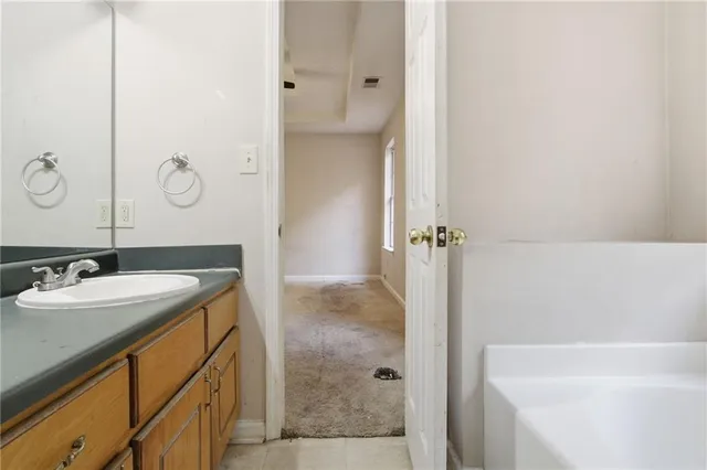 a bathroom with a granite countertop sink a mirror and shower