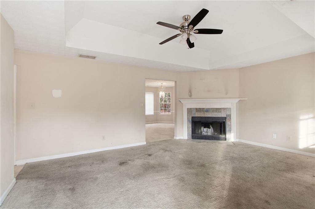 115 Mountainview Drive Covington, GA 30016 - Photo 6 of 22 a view of a livingroom with a fireplace a ceiling fan and a window