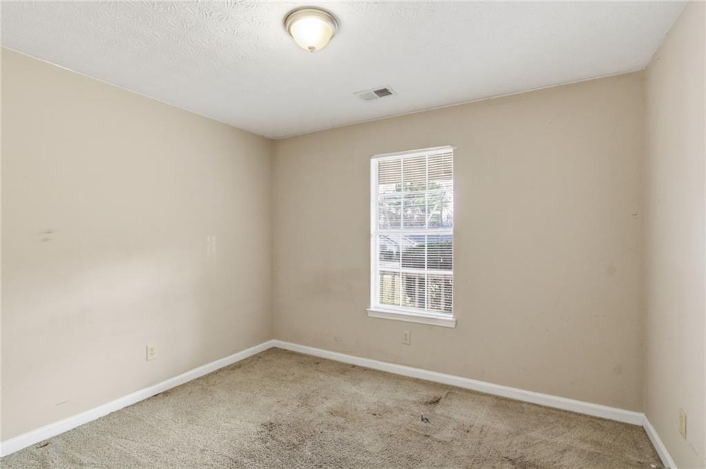 115 Mountainview Drive Covington, GA 30016 - Photo 8 of 22 an empty room with windows