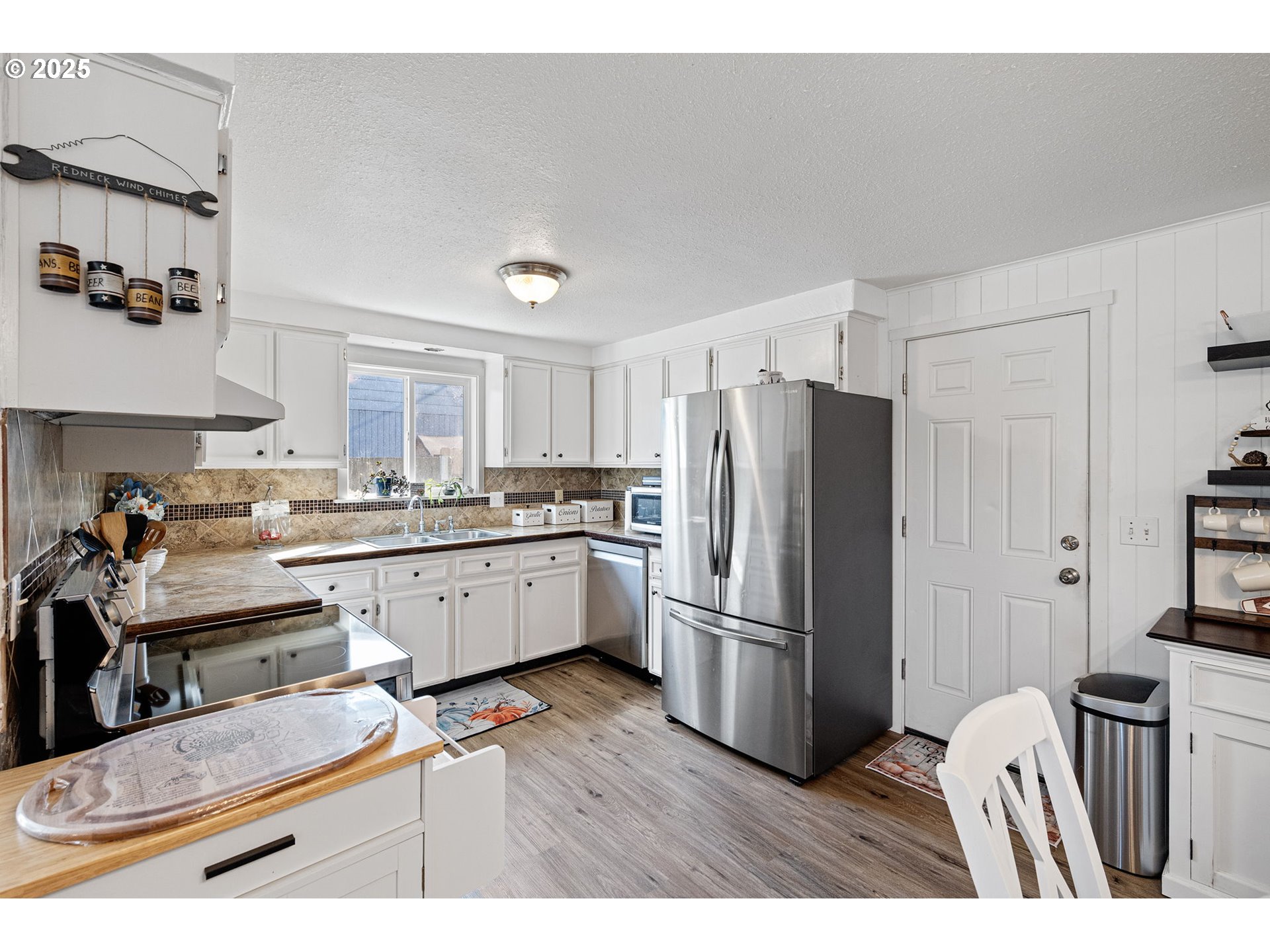 2105 16th Street Florence, OR 97439 - Photo 12 of 48 a kitchen with a refrigerator and a sink