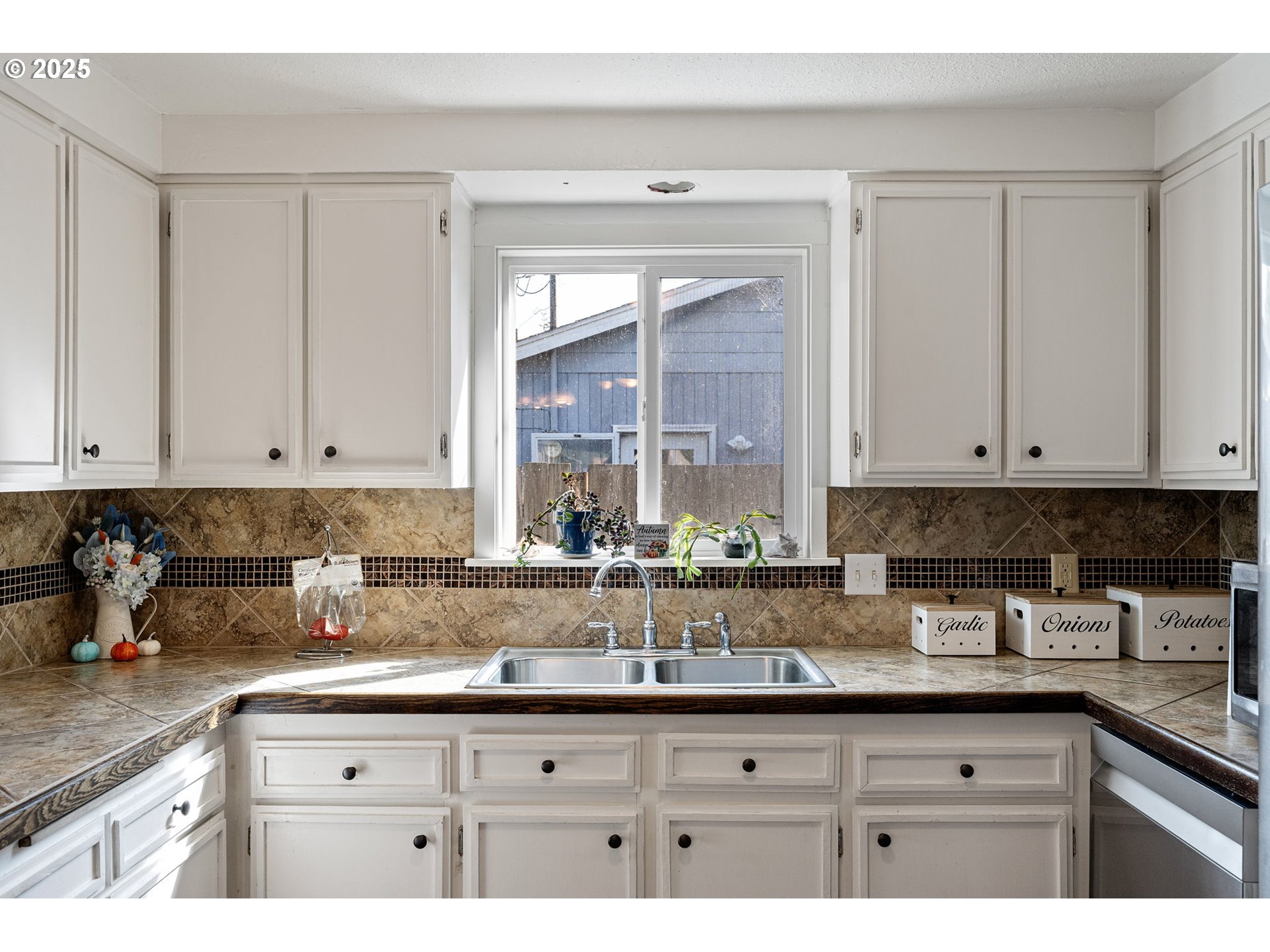 2105 16th Street Florence, OR 97439 - Photo 13 of 48 a kitchen with granite countertop a sink white cabinets and a granite counter tops