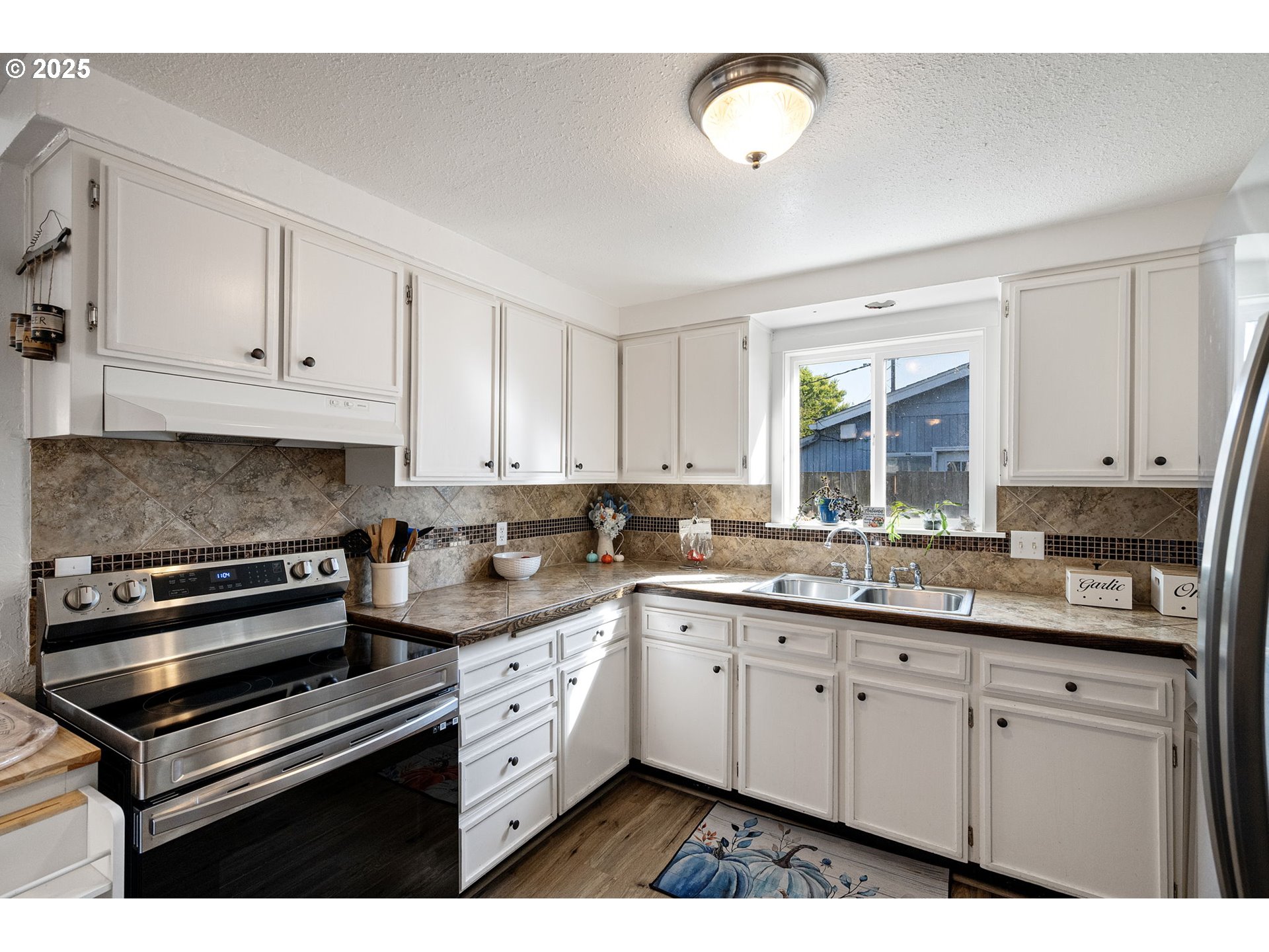 2105 16th Street Florence, OR 97439 - Photo 14 of 48 a kitchen with a sink stove and cabinets