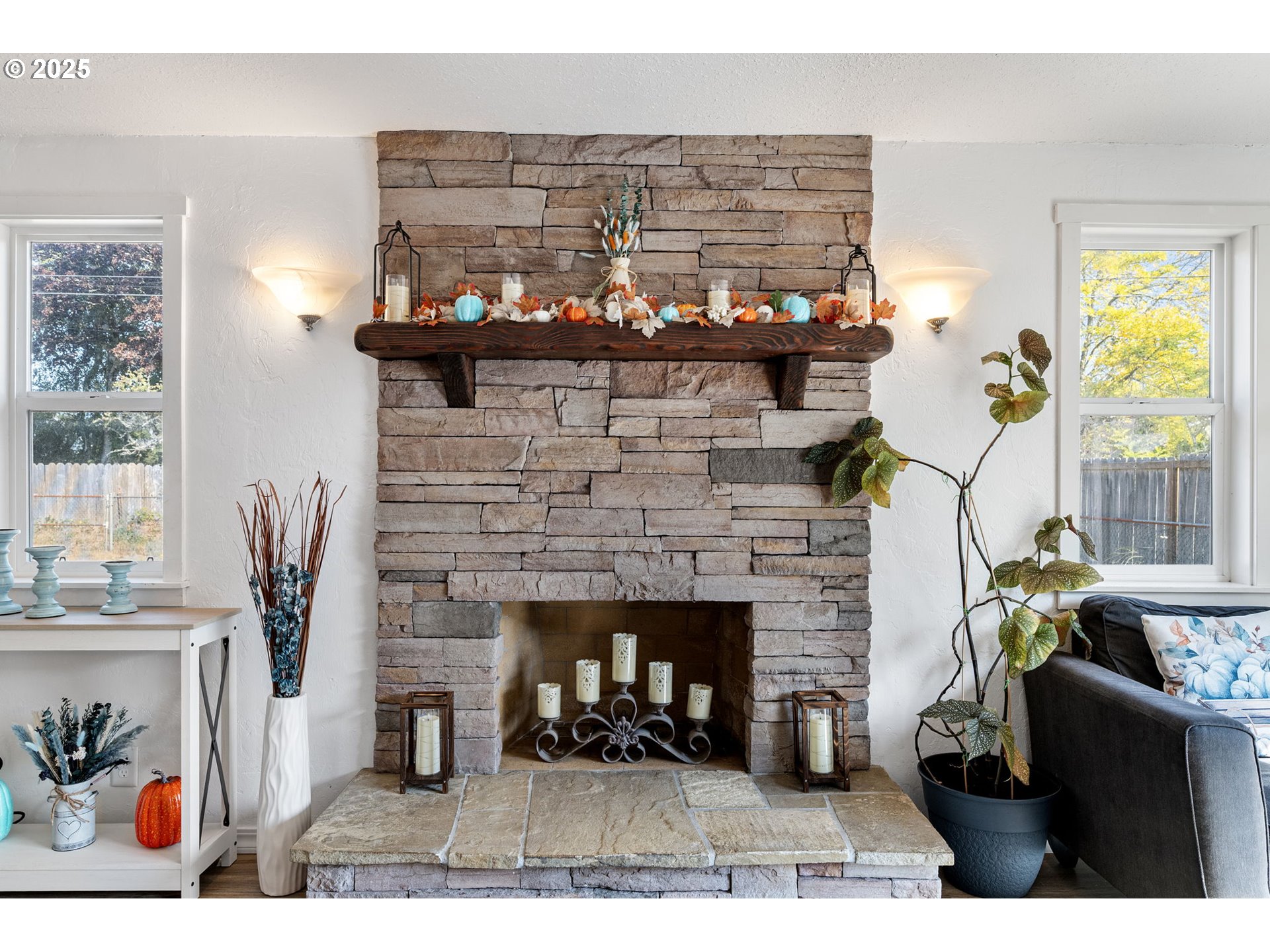 2105 16th Street Florence, OR 97439 - Photo 16 of 48 a living room with furniture a fireplace and a potted plant