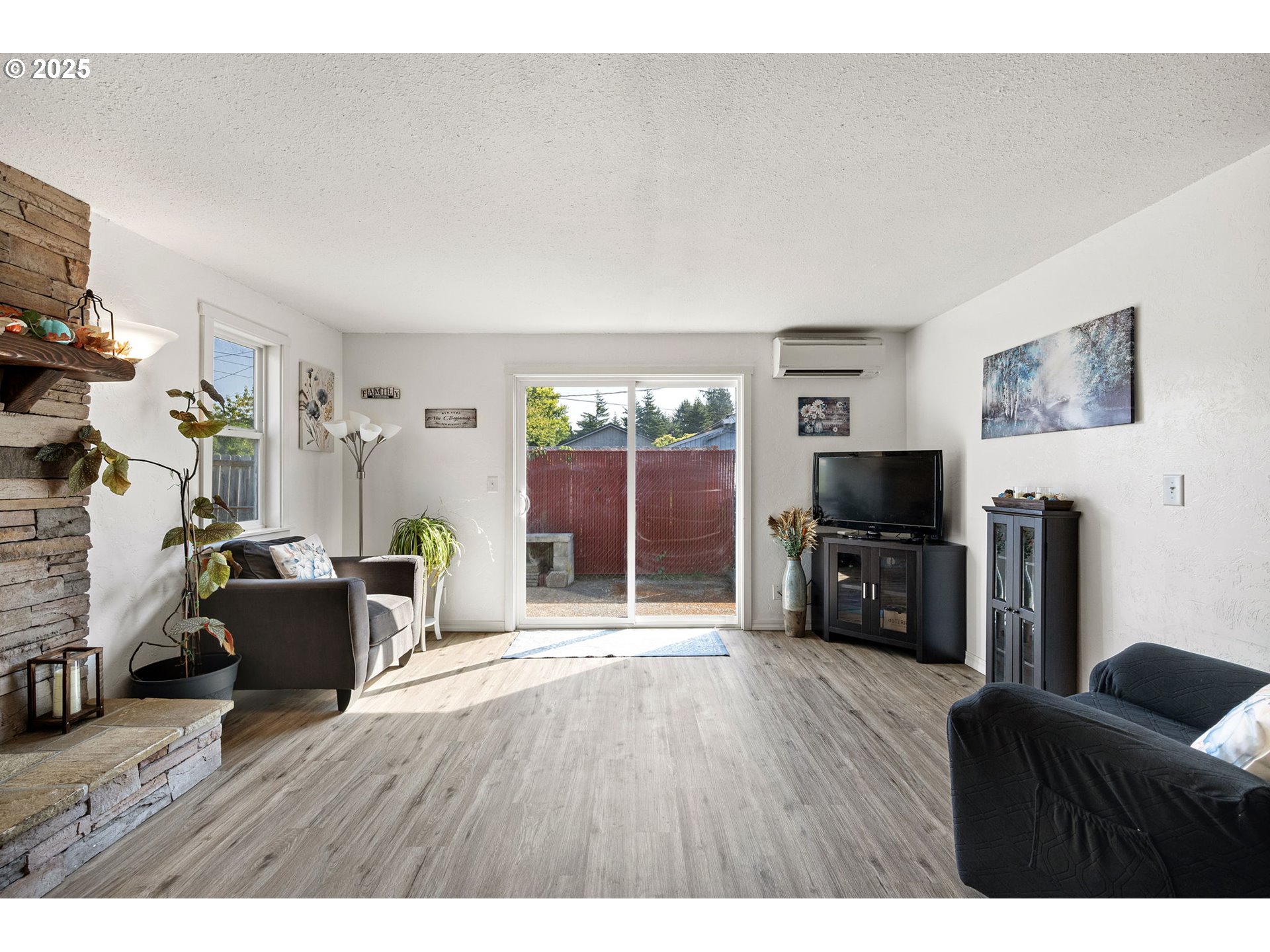2105 16th Street Florence, OR 97439 - Photo 18 of 48 a living room with furniture a flat screen tv and a fireplace