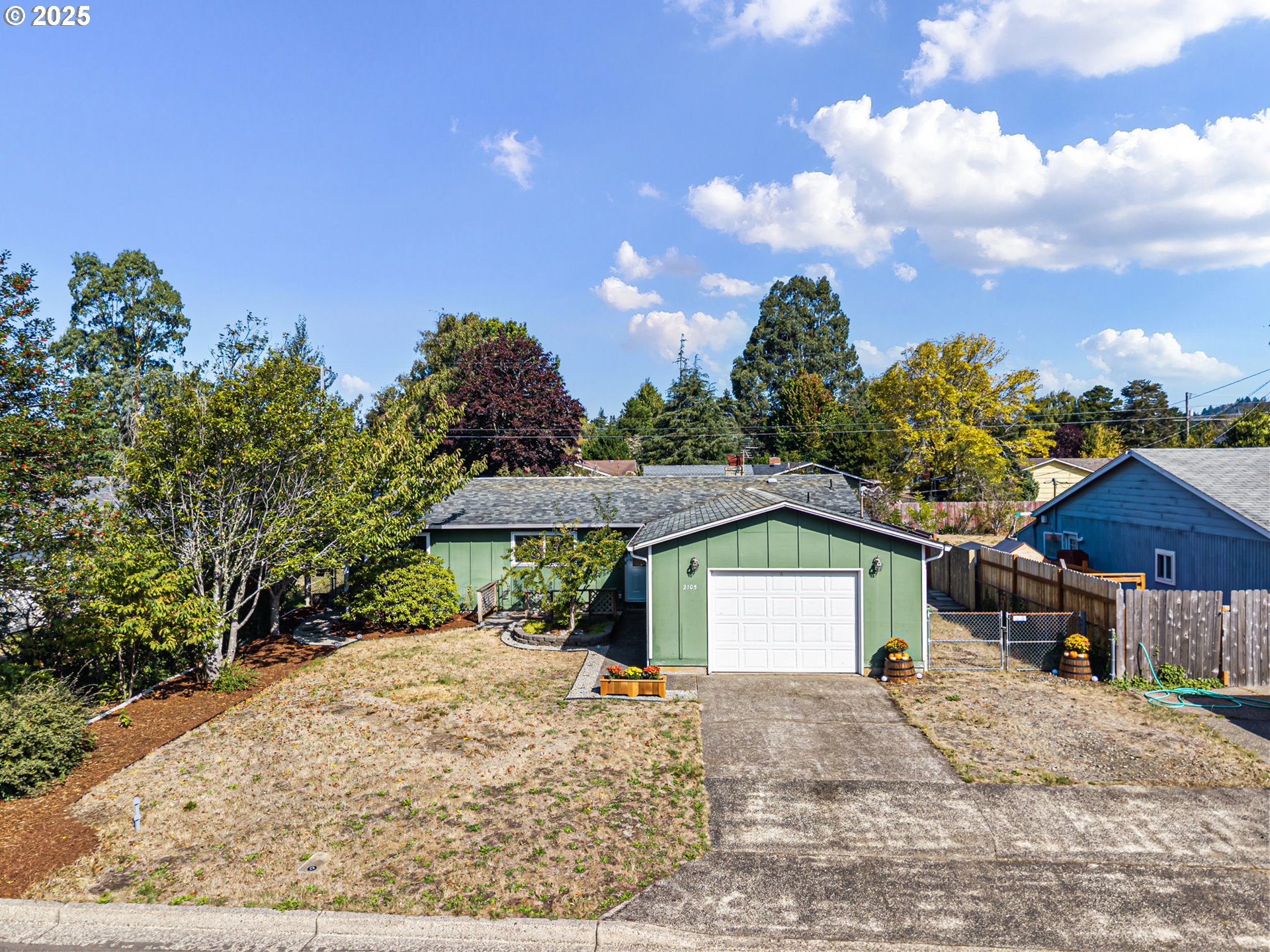 2105 16th Street Florence, OR 97439 - Photo 2 of 48 a view of a house with a yard and garage