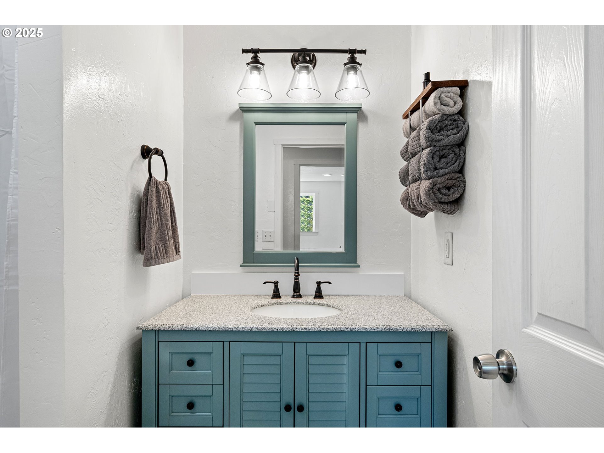 2105 16th Street Florence, OR 97439 - Photo 25 of 48 a bathroom with a sink and a mirror