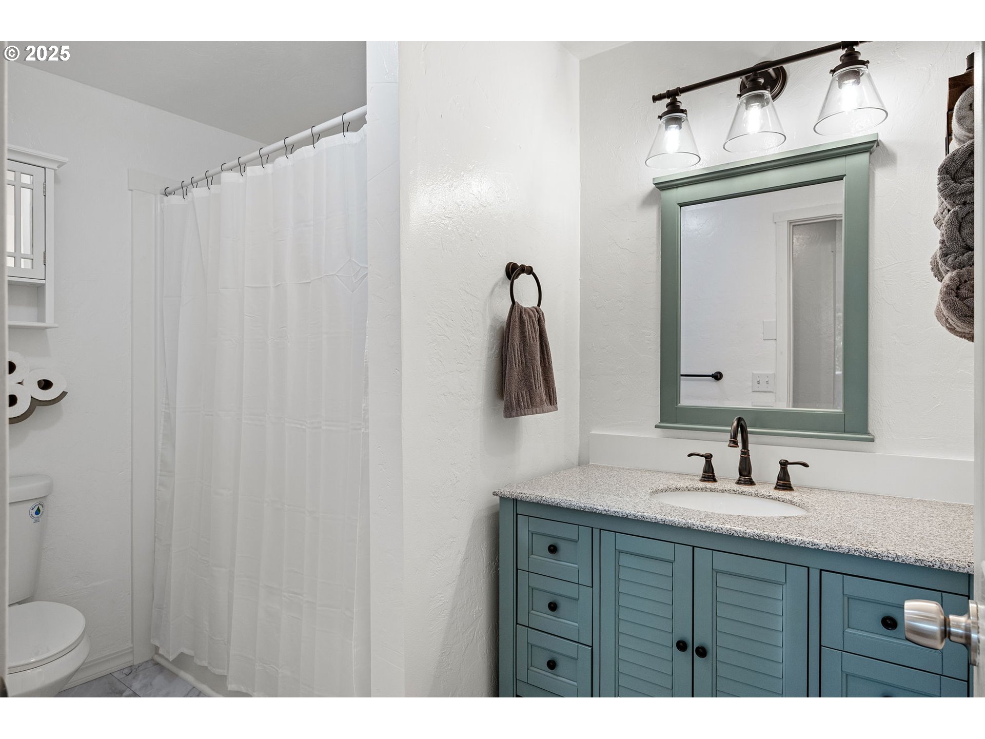 2105 16th Street Florence, OR 97439 - Photo 26 of 48 a bathroom with a sink vanity mirror and toilet